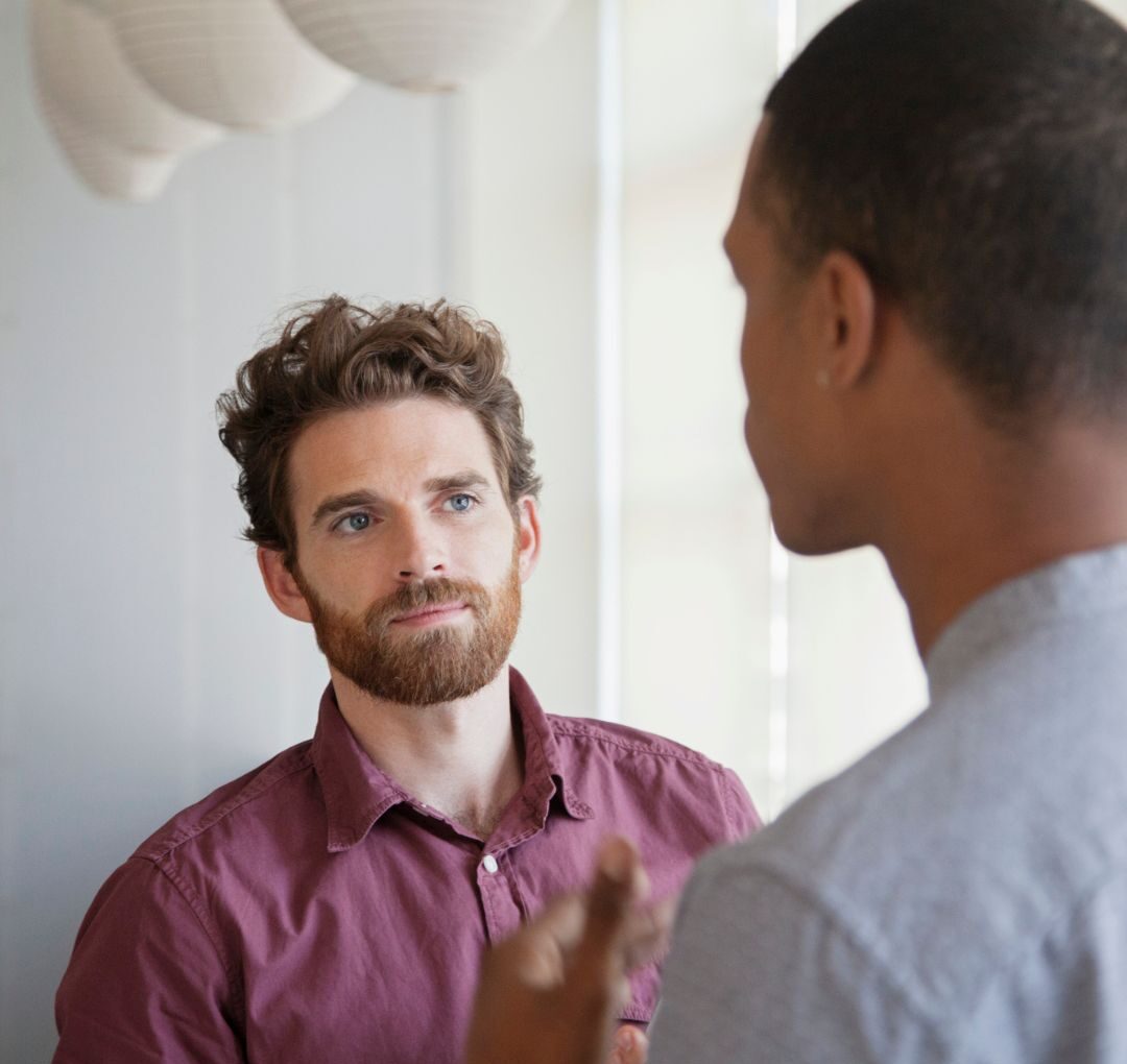 Coach inviting feedback from the client by asking questions to check in on the client progress during a face-to-face coaching session