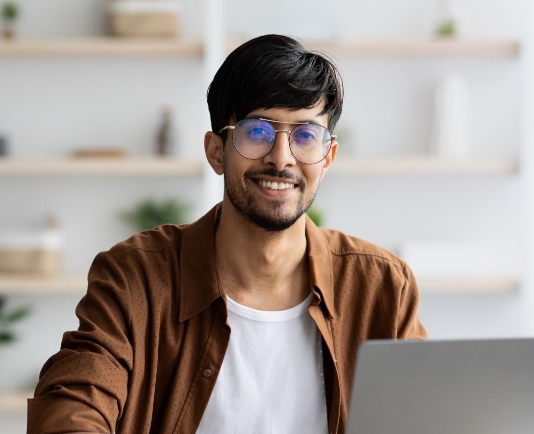 Male Emotional Intelligence Coach ready for a virtual coaching session on his laptop
