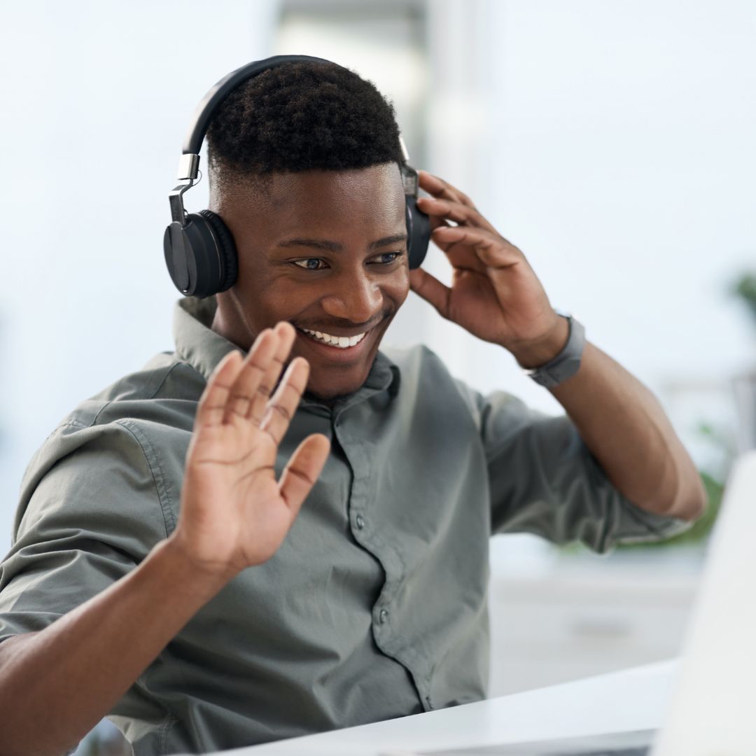 Male coach in a video call raising his hand after an intuition