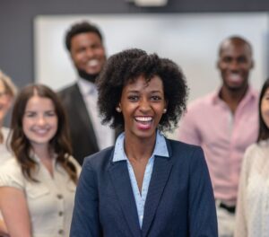 Leadership development coach ready to start a face-to-face group coaching session with a motivated group of leaders standing at her back