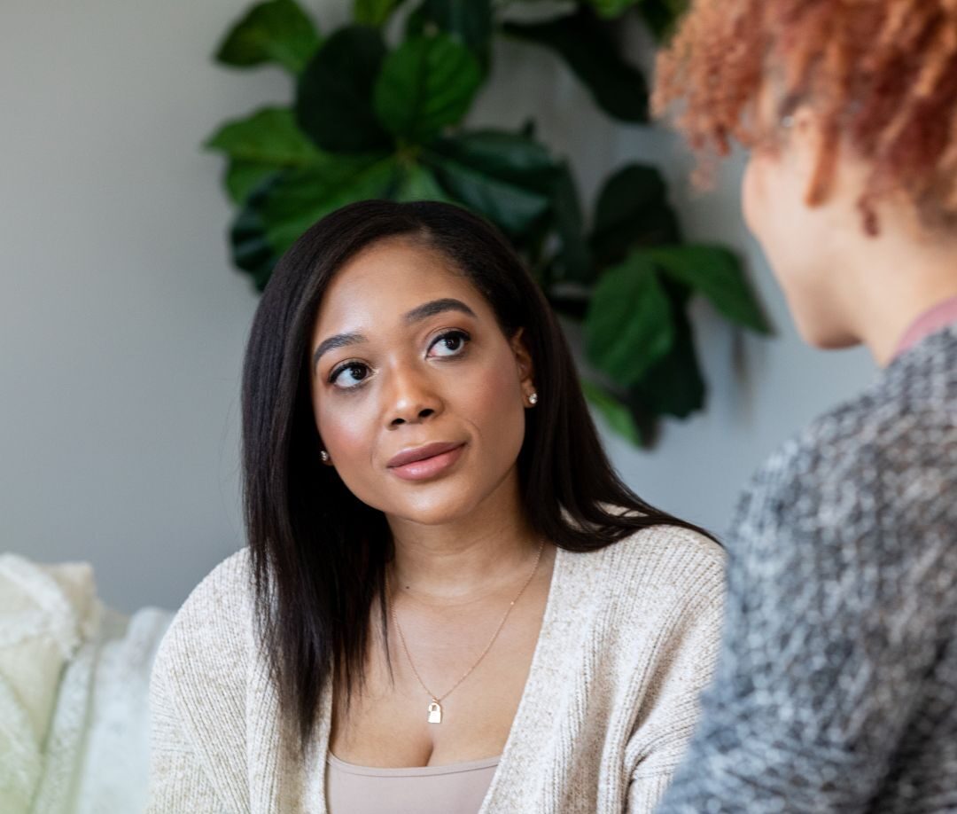 Female coach demonstrating effective communication and active listening at all three levels in a face-to-face leadership coaching conversation with a female executive