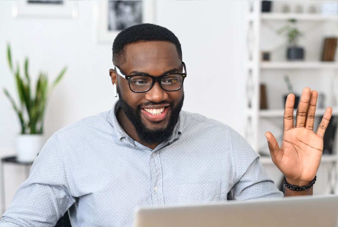 Male coach demonstrating active listening and asking powerful questions as he goes through the arc of a coaching conversation in a virtual session with a client