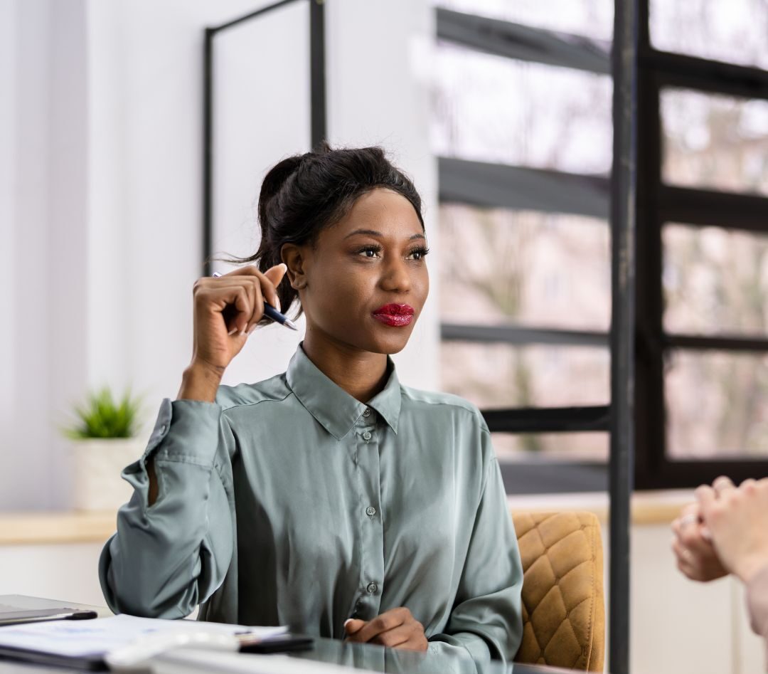 Coach demonstrating exceptional skills by taking a curious stance aimed at perspective shifting during a face-to-face coaching session with an executive