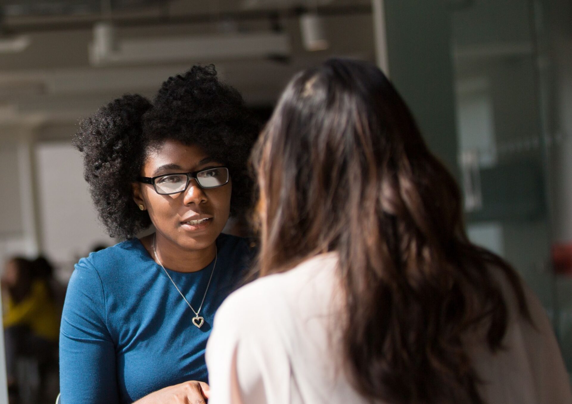 Female coach concluding a face-to-face coaching session with her client, wrapping up the discussion seamlessly to ensure they finish within the allotted time